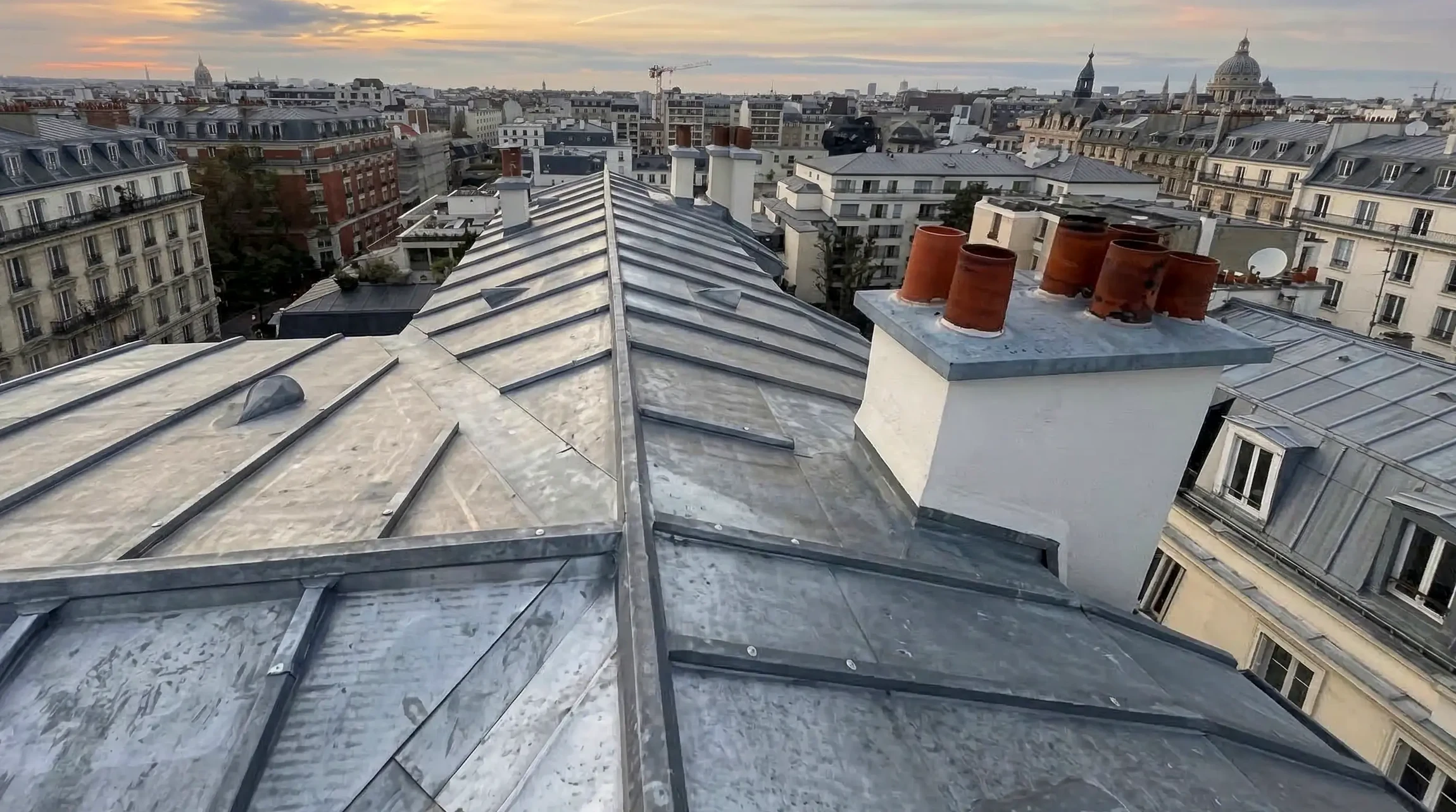 Fa&ccedil;ade ext&eacute;rieure d'une maison moderne avec toiture en tuiles canal terre cuite et goutti&egrave;re m&eacute;tallique apparente